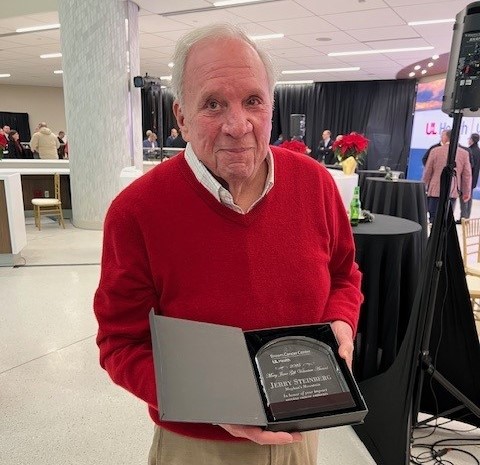 Jerry Steinberg holds the plaque he was awarded as the 2025 Mary Jane Gift Volunteer of the Year award for the UofL Health - Brown Cancer Center